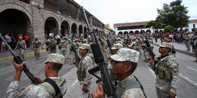 Soldiers stand in formation after arriving as reinforcements amid violent protests following the ousting and arrest of former President Pedro Castillo, in Ayacucho, Peru, December 15, 2022. REUTERS/Miguel Gutierrez Chero.