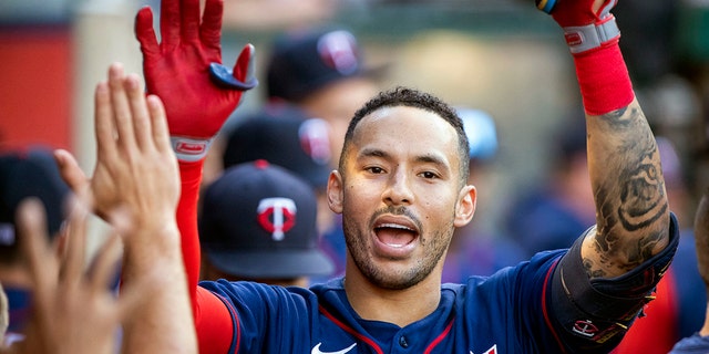Minnesota Twins' Carlos Correa is congratulated after hitting a solo home run against the Los Angeles Angels in Anaheim, California, Aug. 13, 2022.