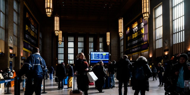 Travelers move through Amtrak's 30th Street Station in Philadelphia on Wednesday, Dec. 21, 2022.