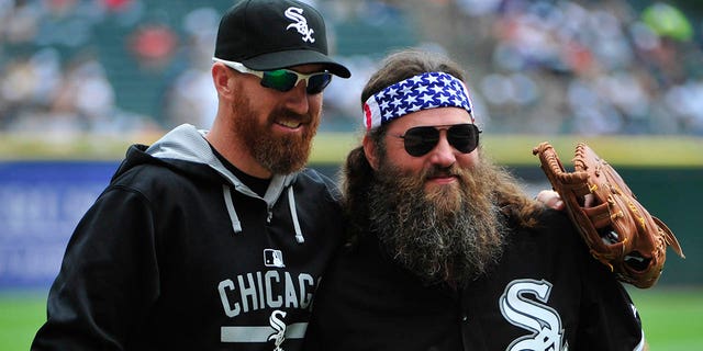 "Duck Dynasty" star Willie Robertson, right, talks with Adam LaRoche, #25 of the Chicago White Sox, after throwing out the ceremonial first pitch before theme between the Chicago White Sox and the Seattle Mariners on Aug. 30, 2015 at U.S. Cellular Field in Chicago.
