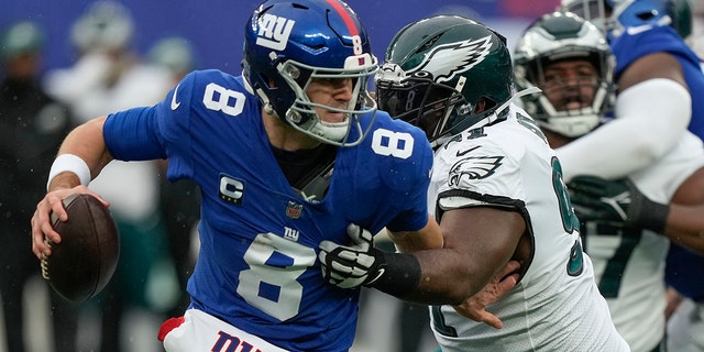 New York Giants quarterback Daniel Jones (8) is pressured by Philadelphia Eagles defensive tackle Fletcher Cox (91) during the second quarter of a game, Sunday, Dec. 11, 2022, in East Rutherford, N.J. 
