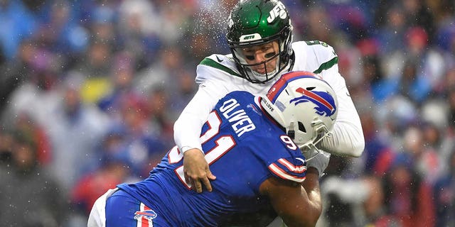 Buffalo Bills defensive tackle Ed Oliver collides with New York Jets quarterback Mike White, Sunday, Dec. 11, 2022, in Orchard Park, New York.