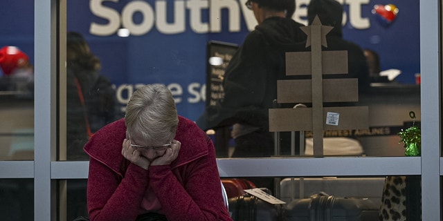 A traveler waits outside the Southwest Airlines baggage office at Oakland International Airport (OAK) in Oakland, California, US, on Wednesday, Dec. 28, 2022.