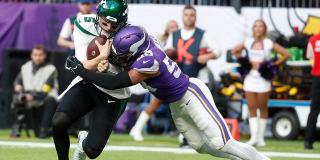 New York Jets quarterback Mike White (5) is tackled by Minnesota Vikings linebacker Jordan Hicks (58) during the second half of an NFL football game, Sunday, Dec. 4, 2022, in Minneapolis. 