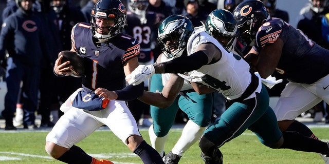 Bears' Justin Fields is tackled by Philadelphia Eagles' Josh Sweat, Sunday, Dec. 18, 2022, in Chicago.