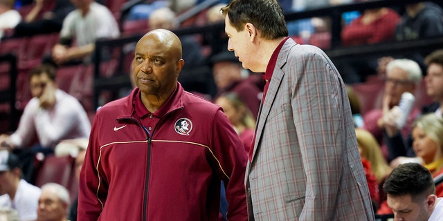 Florida State Seminoles head coach Leonard Hamilton, left, and assistant coach Stan Jones, right, during the second half against the Notre Dame Fighting Irish at Donald L. Tucker Center in Tallahassee, Florida, Dec. 21, 2022.