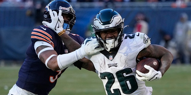 Philadelphia Eagles' Miles Sanders, right, tries to get past of Chicago Bears' Jaquan Brisker during the second half of an NFL football game, Sunday, Dec. 18, 2022, in Chicago.