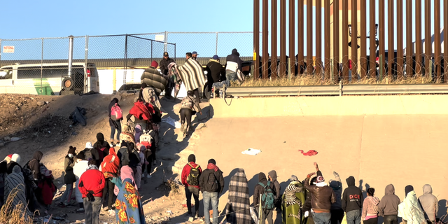 Migrants at the front of the line are processed for entry by Customs and Border Protection.