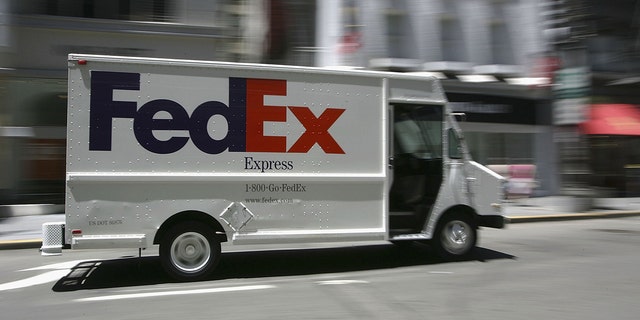 A FedEx delivery truck drives through Union Square in San Francisco.