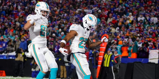 Salvon Ahmed #26 of the Miami Dolphins celebrates after rushing for a touchdown against the Buffalo Bills during the second quarter of the game at Highmark Stadium on December 17, 2022 in Orchard Park, New York.