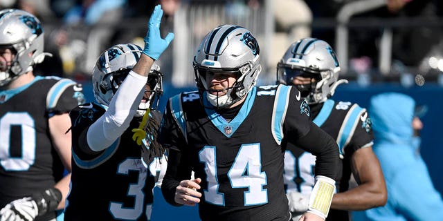 Sam Darnold #14 of the Carolina Panthers celebrates with D'Onta Foreman #33 after a touchdown during the second quarter of the game against the Detroit Lions at Bank of America Stadium on December 24, 2022, in Charlotte, North Carolina.