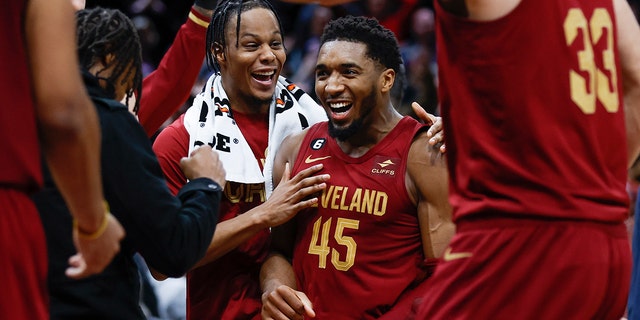 Cleveland Cavaliers guard Donovan Mitchell, #45, celebrates with teammates after making a basket to tie an NBA basketball game during the second half against the Chicago Bulls, Monday, Jan. 2, 2023, in Cleveland. 