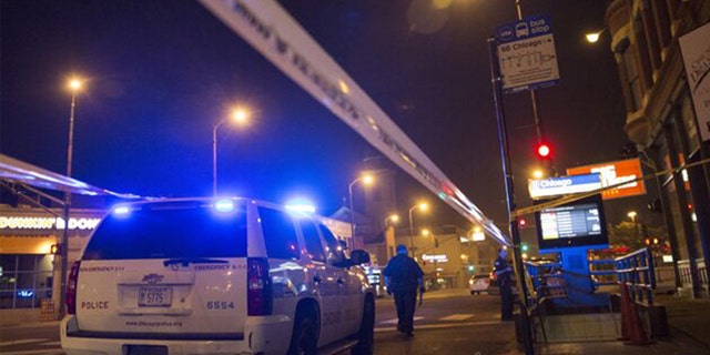 Chicago police officer investigates a crime scene of a gunshot victim in Chicago.