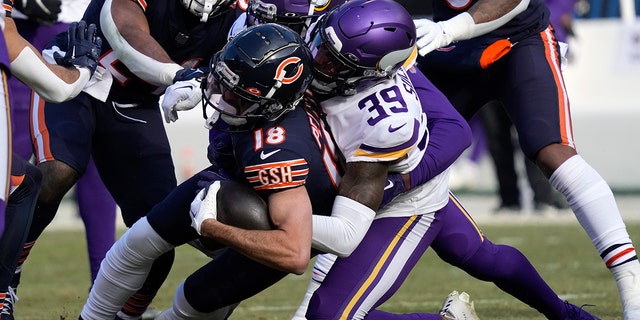 Chicago Bears wide receiver Dante Pettis (18) is tackled by Minnesota Vikings cornerback Chandon Sullivan (39) after catching a pass during the first half of an NFL football game, Sunday, Jan. 8, 2023, in Chicago.