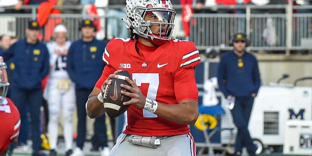 C.J. Stroud of the Ohio State Buckeyes looks to throw a pass against the Michigan Wolverines at Ohio Stadium on November 26, 2022, in Columbus, Ohio.