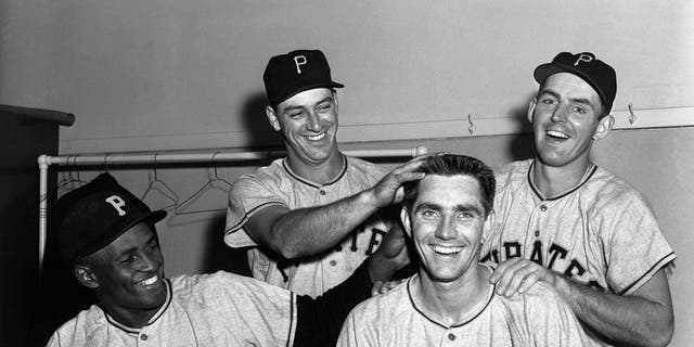 Jubilant members of the Pittsburgh Pirates celebrate in dressing room here 6/6 after beating the Cubs, 8-2, to retain their slim lead as league leaders.