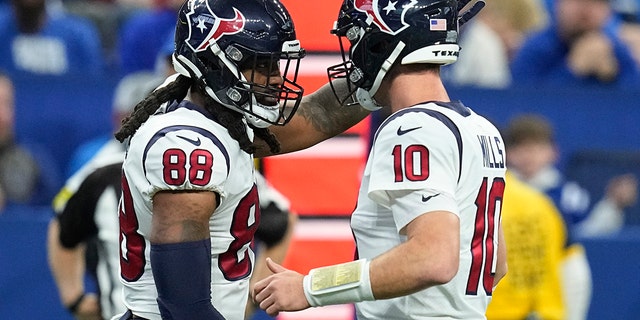 Houston Texans tight end Jordan Akins (88) celebrates with quarterback Davis Mills after scoring on a 19-yard touchdown pass during the second half, Jan. 8, 2023, in Indianapolis.