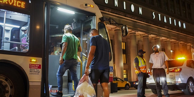A group of migrants board a CTA bus at Chicago&amp;apos;s Union Station to be taken to a Salvation Army shelter after arriving from Texas on Aug. 31, 2022. 