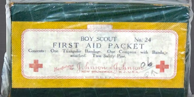 Johnson &amp; Johnson helped popularize Band-Aids in the 1920s by sending them out in the field in first-aid kits for the Boy Scouts of America. The original 1925 "Boy Scout First Aid Packet" had a triangular bandage for a sling, a compress and two safety pins. It came in a cardboard container.