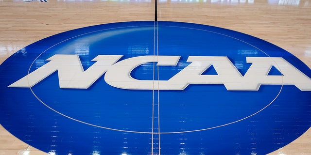 In this March 18, 2015, file photo, the NCAA logo is displayed at center court as work continues at the Consol Energy Center in Pittsburgh for the NCAA basketball tournament.
