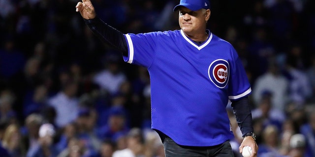 Former Cubs player Ryne Sandberg waves before throwing out a ceremonial first pitch before the National League Championship Series game between Los Angeles and Chicago at Wrigley Field on Oct. 18, 2017.