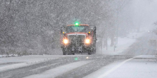 A Wayne County Department of Public Services truck salts a road, Wednesday, Jan. 25, 2023, in Wayne, Michigan.