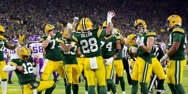 AJ Dillon #28 of the Green Bay Packers celebrates with teammates after rushing for a touchdown against the Minnesota Vikings during the fourth quarter of the game at Lambeau Field on January 01, 2023 in Green Bay, Wisconsin.