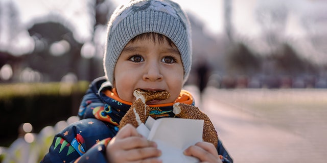 A child enjoys a sesame-covered snack. "Allergy moms can’t get the word out fast enough that [some] companies are threatening the lives of our kids," one mom insisted.