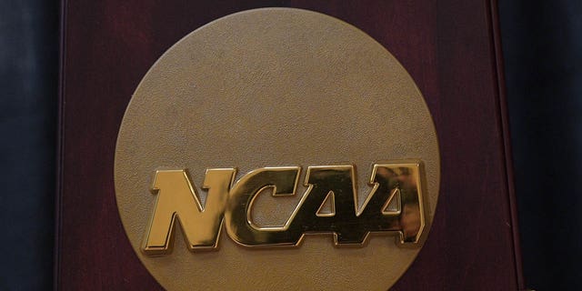 The NCAA logo on the 2023 Division I Men's basketball national championship trophy on display prior to a basketball game between the Maine Black Bears and the Brown Bears Nov. 27, 2022, at Pizzitola Sports Center in Providence, R.I.