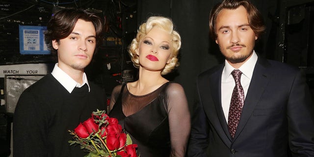 From left, Dylan Jagger Lee, Pamela Anderson and Brandon Thomas Lee pose backstage during the opening night of her Broadway debut as Roxie Hart in the musical "Chicago" on Broadway.