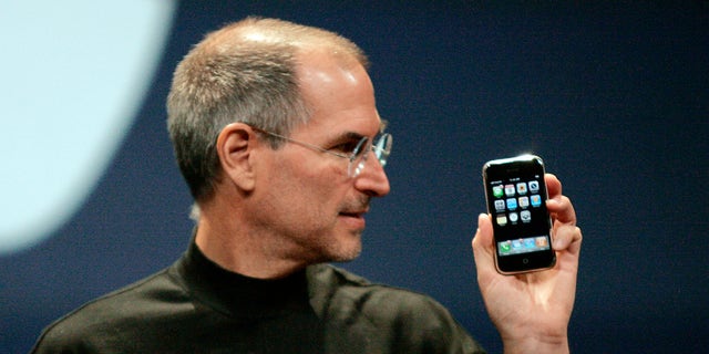 Then-Apple CEO Steve Jobs holds the iPhone in San Francisco, California, on Jan. 9, 2007. 