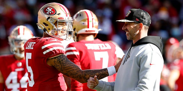 Trey Lance (5) of the San Francisco 49ers and head coach Kyle Shanahan of the San Francisco 49ers talk before a game against the Houston Texans at Levi's Stadium Jan. 2, 2022 in Santa Clara, Calif.