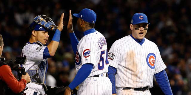 Cubs teammates, from left, Willson Contreras, Aroldis Chapman and Anthony Rizzo celebrate after game five of the World Series against the Cleveland Indians, Oct. 30, 2016, in Chicago.