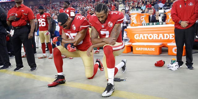 In this Sept. 12, 2016, file photo, San Francisco 49ers safety Eric Reid (35) and quarterback Colin Kaepernick (7) kneel during the national anthem before an NFL football game.
