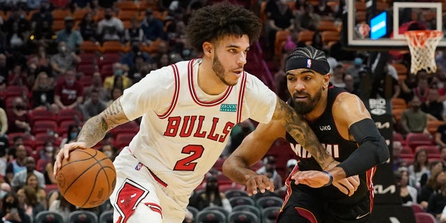 Chicago Bulls guard Lonzo Ball, left, drives to the basket as Miami Heat guard Gabe Vincent, right, defends during the first half of an NBA basketball game, Saturday, Dec. 11, 2021, in Miami. 