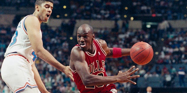 Michael Jordan of Chicago, working his way around Brad Daugherty, heads toward the basket at the Coliseum.