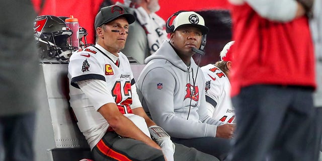 Buccaneers quarterback Tom Brady sits with offensive coordinator Byron Leftwich during the NFC wild-card game against the Dallas Cowboys on Jan. 16, 2023, at Raymond James Stadium in Tampa, Florida.