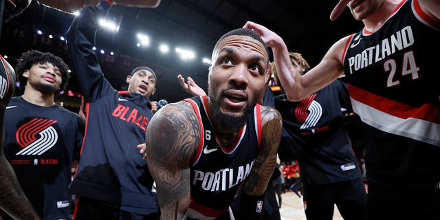 Damian Lillard, #0 of the Portland Trail Blazers, celebrates with teammates after a 134-124 victory over the Utah Jazz at Moda Center on Jan. 25, 2023 in Portland, Oregon.