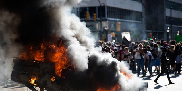 Smoke rises from a burning police vehicle in Philadelphia on May 30, 2020, during protests that swept the country in the wake of George Floyd's death.