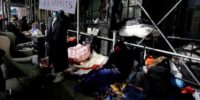 Migrants camp out in front of the Watson Hotel after being evicted, on Feb. 1, 2023 in New York City.