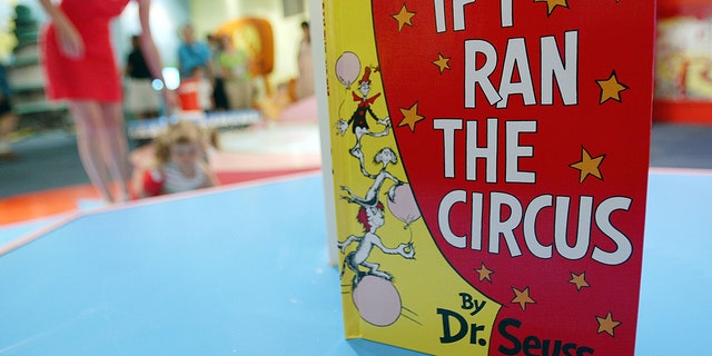 NEW YORK - JULY 6:  A Dr. Seuss book is seen as children play during a press preview of an interactive exhibition dedicated to Dr. Seuss at the Children's Museum of Manhattan July 6, 2004 in New York City. The 4,000 square-foot exhibit is titled, 'Oh Suess! Off to Great Places' and will remain open at the museum until July 2005.  (Photo by Mario Tama/Getty Images)