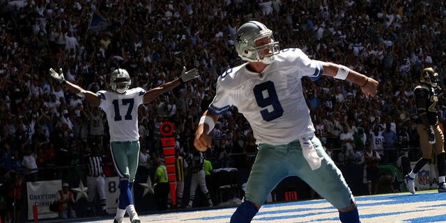Quarterback Tony Romo (9) and wide receiver Sam Hurd (17) of the Dallas Cowboys celebrate after Romo's 15-yard touchdown run against the St. Louis Rams at Texas Stadium Sept. 30, 2007, in Irving, Texas. 
