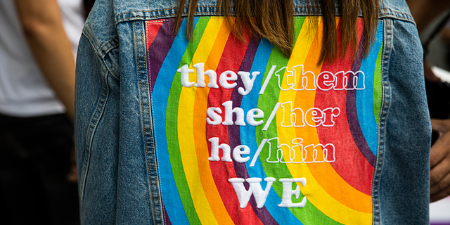 A person wears a gender neutral pronoun jacket at a 'Rainbow Runway for Equality' to kick off Pride Month at Central World Mall on June 01, 2022, in Bangkok, Thailand. (Photo by Lauren DeCicca/Getty Images)