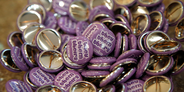 Buttons with the "they, them, theirs" pronouns are displayed during the ClexaCon 2021 convention at the Tropicana Las Vegas on October 09, 2021 in Las Vegas, Nevada. (Photo by Gabe Ginsberg/Getty Images)