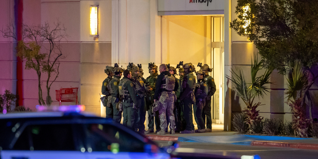 Police officers gather at an entrance of a shopping mall, Wednesday, Feb. 15, 2023, in El Paso, Texas. Police say one person was killed and three other people were wounded in a shooting at Cielo Vista Mall. One person has been taken into custody, El Paso police spokesperson Sgt. Robert Gomez said. 