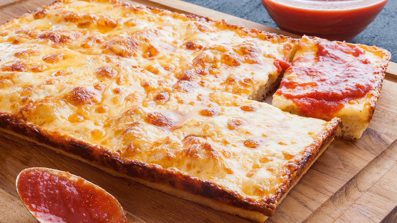 Detroit style pizza is a deep dish style of pizza covered with cheese, even on the crust. 