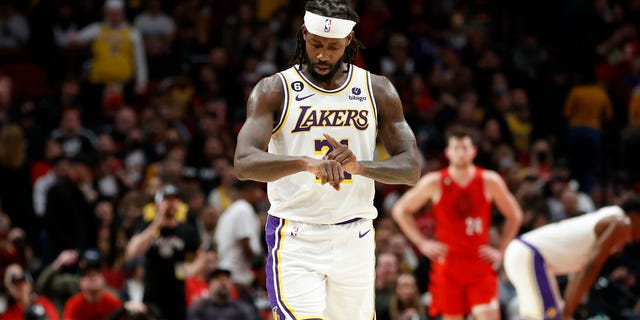 Patrick Beverley #21 of the Los Angeles Lakers mimics Damian Lillard's "Dame Time" signature gesture during the fourth quarter against the Portland Trail Blazers at Moda Center on January 22, 2023 in Portland, Oregon.