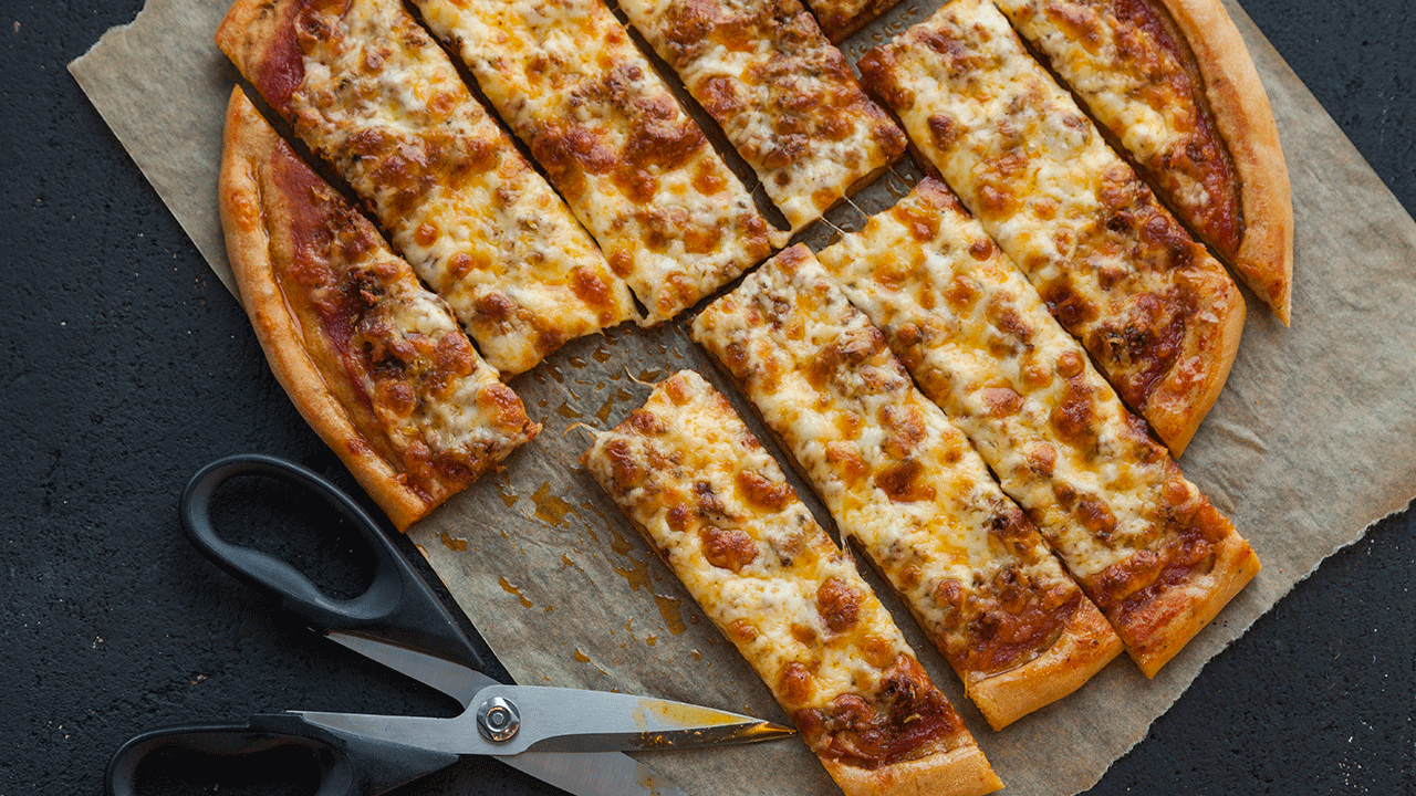 Quad City style pizza is cut in strips, giving it a look similar to a breadstick. 