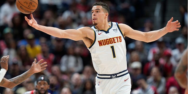 Denver Nuggets forward Michael Porter Jr. pulls in a loose ball in the first half of an NBA basketball game against the Chicago Bulls Wednesday, March 8, 2023, in Denver. 