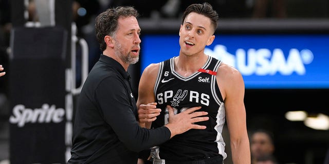 San Antonio Spurs' Zach Collins, right, is restrained by Spurs assistant coach Matt Nielsen after an altercation on the court in the second half of an NBA basketball game against the Denver Nuggets, Friday, March 10, 2023, in San Antonio. 